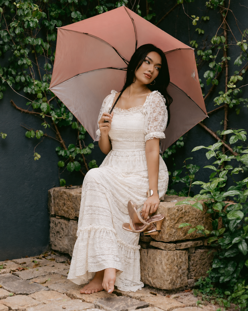 Pearl White Romantic Lace Gown seated with umbrella