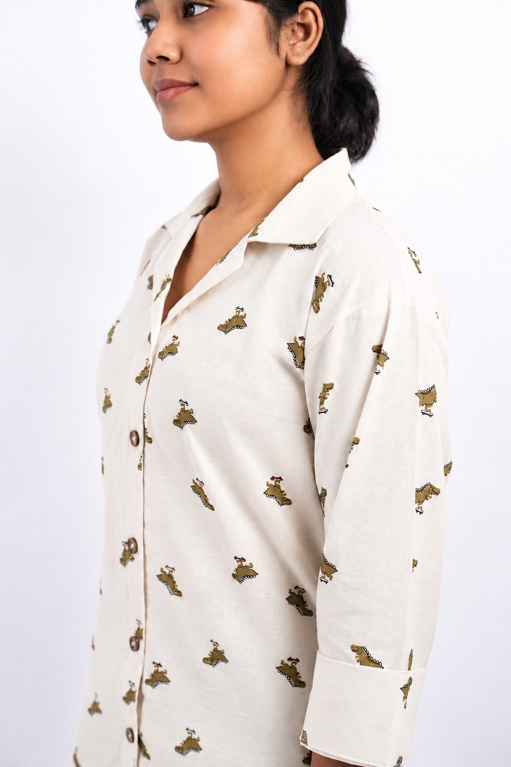 Dino Daze close side view showing the Cuban collar, dinosaur print and three-quarter sleeve on an ivory shirt.