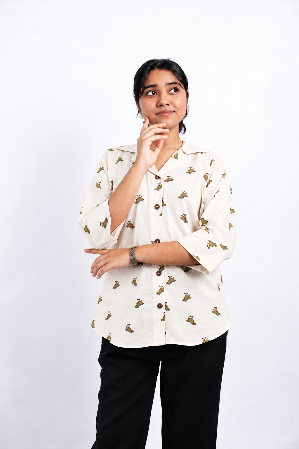 Dino Daze ivory dinosaur-print ladies shirt, front studio pose showing Cuban collar, brown buttons, relaxed fit and curved hem.