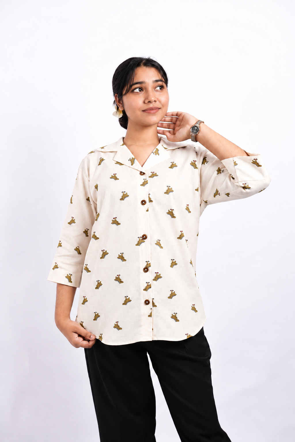 Dino Daze ivory ladies shirt with small dinosaur prints, three-quarter sleeves and brown buttons, shown in a relaxed front studio pose.